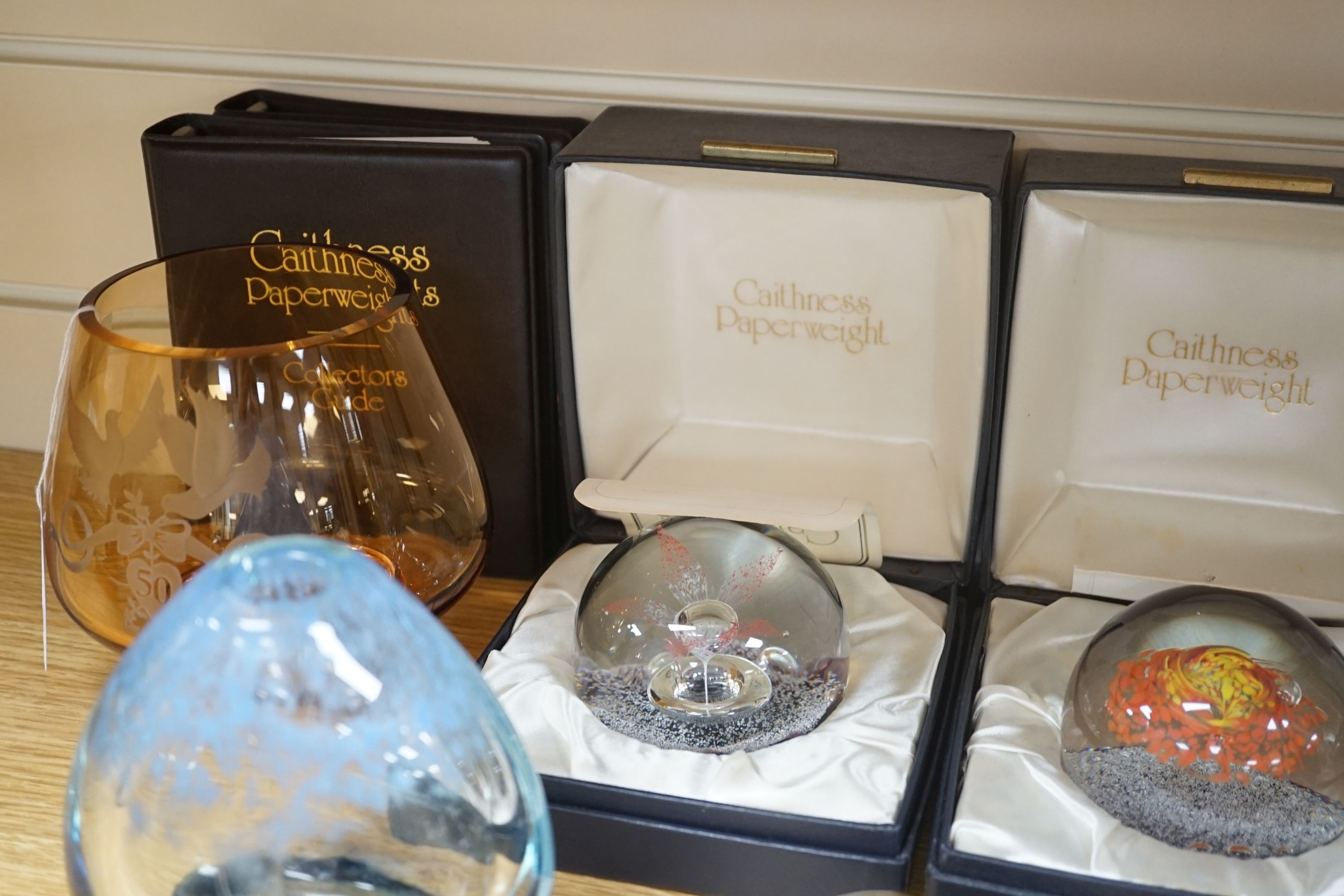 2 Caithness glass vases together with 11 various paperweights, including 3 boxed Caithness and a Baccarat paperweight.